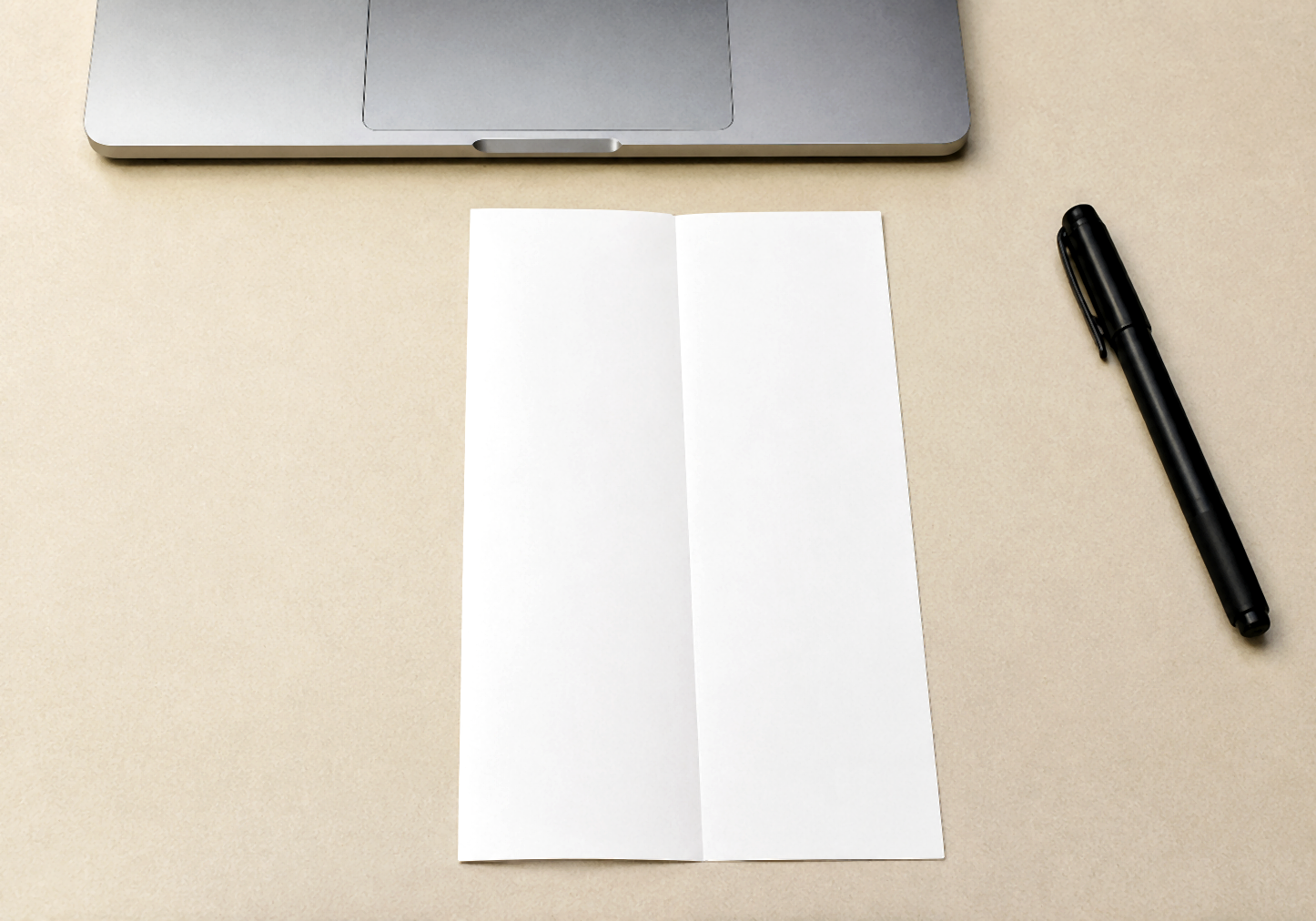 Folded sheet opened to show a central crease on the desk.