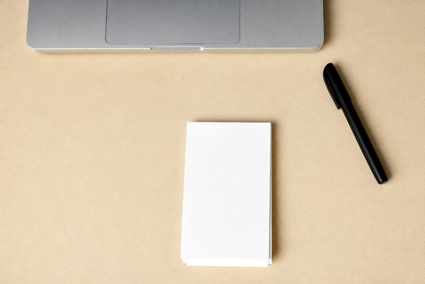 Folded PocketMod stack on a desk with a black pen to the right.