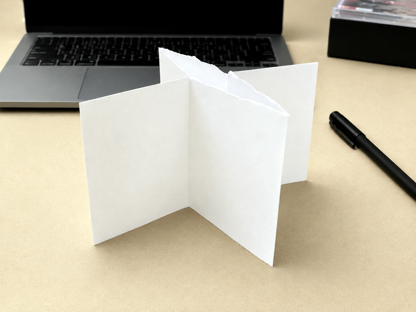 PocketMod partially collapsed into booklet form on a desk.
